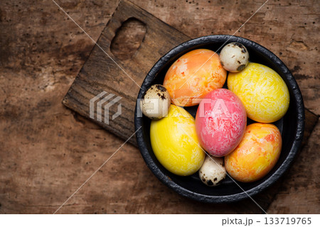 Assorted Colorful Eggs in Bowl on Rustic Wood Background Assorted Colorful Eggs in Bowl on Rustic Wood Background 133719765