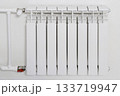 white radiator with a white pipe attached to it 133719947