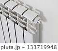A white radiator with a white pipe attached to it 133719948