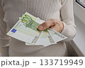 Old person is holding three 100 euro bills 133719949