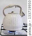 new white kettle on the gas stove 133719950