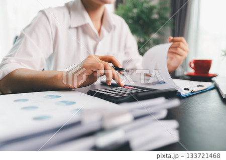 Business woman analyze calculate company financial, tax results office accounting statistics analytical research. calculating business balance prepare tax reduction. Tax deduction planning concept. 133721468