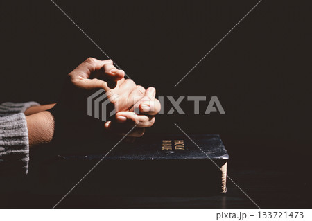 Hands clasped in prayer over the Holy Bible, symbolizing faith, devotion, Christianity, hope and spiritual strength through God Word, worship, meditation and encouragement. Hands clasped in prayer over the Holy Bible, symbolizing faith, devotion, Christianity, hope and spiritual strength through God Word, worship, meditation and encouragement. 133721473