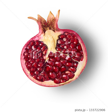 Flying in air fresh ripe whole and cut pomegranate with seeds and leaves isolated. High resolution image Flying in air fresh ripe whole and cut pomegranate with seeds and leaves isolated. High resolution image 133722906