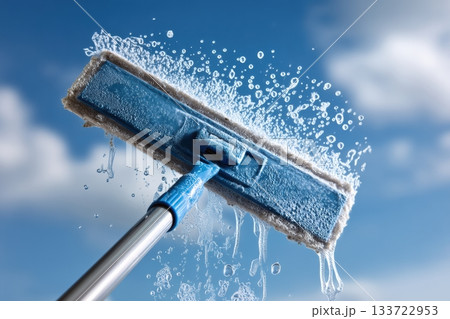 Highspeed shot capturing water arcs during window cleansing scene, Dynamic image showcasing microfiber pad in action against bright sky with sparkling clean glass 133722953