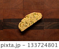 Home baked pistachio and orange biscotti on a wooden cutting board 133724801