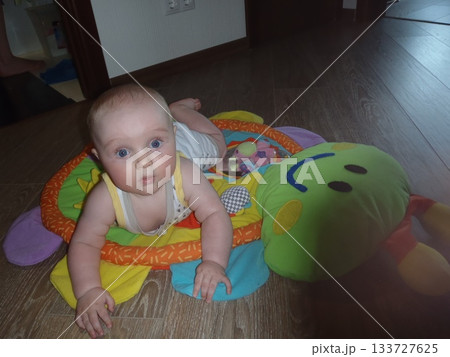 Baby on Developmental Mat Engaged in Playtime Baby on Developmental Mat Engaged in Playtime 133727625