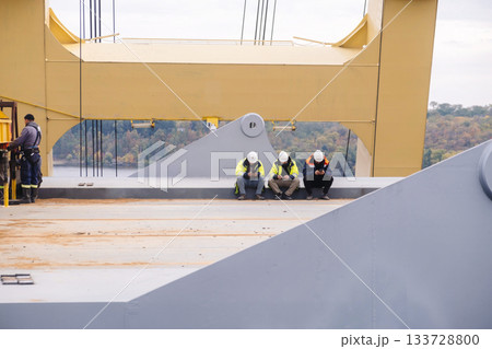 Engineers uses mobile phone wasting time on workplace, Industrial worker using mobile smartphone in industry Engineers uses mobile phone wasting time on workplace, Industrial worker using mobile smartphone in industry 133728800