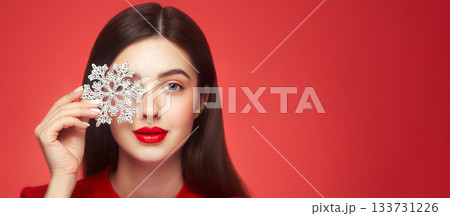 Beautiful young woman with glowing snowflake Beautiful young woman with glowing snowflake 133731226