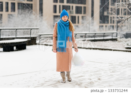 Young woman goes for a walk in the yard and takes out the trash Young woman goes for a walk in the yard and takes out the trash 133731244