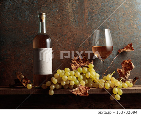 White wine with grapes and dried up vine leaves. 133732094
