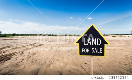 land for sale sign against trimmed lawn background. Empty dry cracked swamp reclamation soil, land plot for housing construction project in rural area and beautiful blue sky 133732584