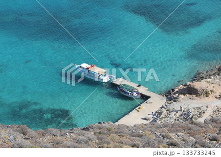 Boat at the pier top view, clear blue water in Greece, near the rocks 133733245