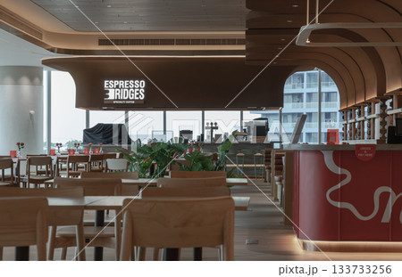 Contemporary design meets urban views in this modern cafe, featuring graceful, curved wooden elements and large windows overlooking the city. Contemporary design meets urban views in this modern cafe, featuring graceful, curved wooden elements and large windows overlooking the city. 133733256