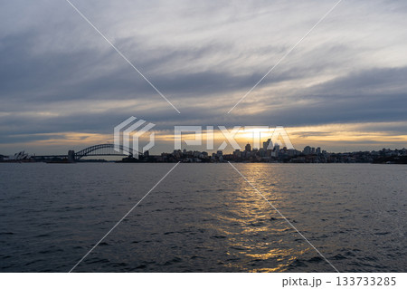 Sydney skyline at sunset with golden reflections on the water 133733285