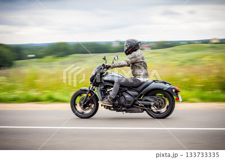 motorbike on the road riding. having fun driving the empty road on a motorcycle tour journey. copyspace for your individual text. Fast Motion Blur effect motorbike on the road riding. having fun driving the empty road on a motorcycle tour journey. copyspace for your individual text. Fast Motion Blur effect 133733335