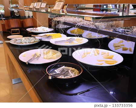 Buffet Cheese Platter Display With Sliced Cheeses and Tongs in Hotel Buffet Setting Buffet Cheese Platter Display With Sliced Cheeses and Tongs in Hotel Buffet Setting 133733356