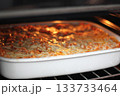 Cooked hot lasagna. A single serving of lasagna served on a clean white plate, perfect for food photography or a simple meal setting 133733464