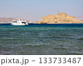 Seascape with ancient castle of Salah ad-Din on Faroun Island in Gulf of Aqaba and yacht in Red Sea. Old fortress of Sultan Salah ad-Din in Taba, travel around Sinai Peninsula. 133733487