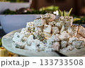 Greek feta cubes with herbs and spices, diced soft cheese isolated on white background with clipping path 133733508