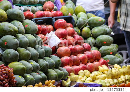 Seasonal Egyptian mango, pomegranate on market. Green mango, red pomegranate in boxes. Many green mangoes. Big mango. Mango season in Egypt. 133733534