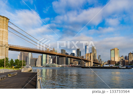 Architecture of historic bridge in Brooklyn. Way to Manhattan. Brooklyn bridge in New York. Manhattan cityscape. Amazing scenery of Brooklyn bridge over skyscraper in New York. NY city Architecture of historic bridge in Brooklyn. Way to Manhattan. Brooklyn bridge in New York. Manhattan cityscape. Amazing scenery of Brooklyn bridge over skyscraper in New York. NY city 133733564