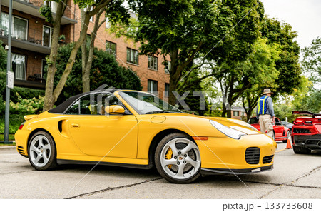 Chicago, Illinois - September 29, 2024: Porsche 911 turbo Carrera S yellow color. Porsche 911 turbo Carrera S on the road 133733608