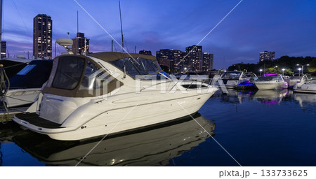 Yacht club. Marina in night. Summer vacation. Downtown city marina with luxury illuminated yacht. Docked vessels. Luxury yacht in night marina. Luxury yacht at night. Night view. Luxury life 133733625