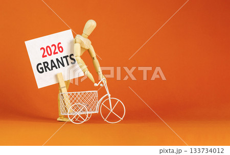 2026 Grants symbol. Concept words 2026 Grants on beautiful white card. Beautiful orange paper background. Businessman's model. Business and 2026 grants concept. Copy space. 133734012