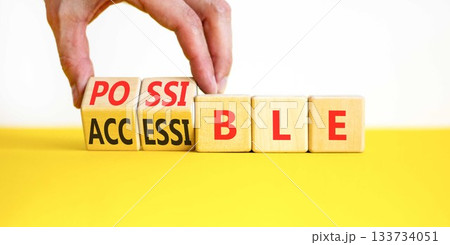 Accessible or possible symbol. Concept words Accessible or Possible on beautiful wooden blocks. Beautiful white background. Doctor's hand. Business accessible or possible concept. Copy space. 133734051