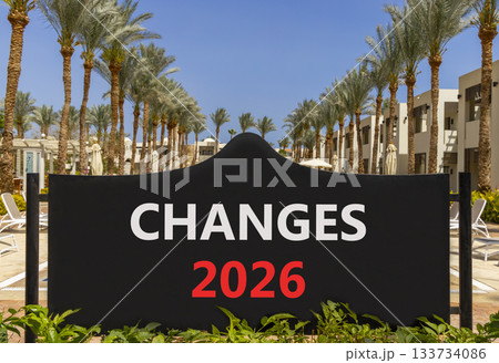 Changes 2026 symbol. Concept words Changes 2026 on beautiful black road sign. Beautiful palm trees palm-trees and blue sky background. Business and changes 2026 concept. Copy space. Changes 2026 symbol. Concept words Changes 2026 on beautiful black road sign. Beautiful palm trees palm-trees and blue sky background. Business and changes 2026 concept. Copy space. 133734086