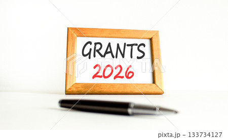 Grants 2026 symbol. Concept words Grants 2026 on beautiful wooden picture frame. Beautiful white paper background. Beautiful black pen. Business and grants 2026 concept. Copy space. Grants 2026 symbol. Concept words Grants 2026 on beautiful wooden picture frame. Beautiful white paper background. Beautiful black pen. Business and grants 2026 concept. Copy space. 133734127