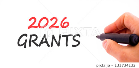 2026 Grants symbol. Concept words 2026 Grants on beautiful white paper. Beautiful white paper background. Businessman's hand with pen. Business and 2026 grants concept. Copy space. 133734132