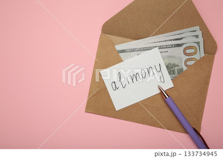 Envelope with word Alimony and money on pink background. 133734945
