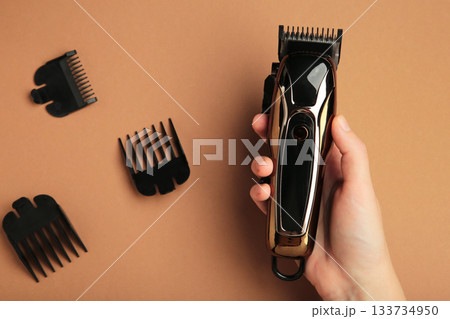 Hair clipper on brown background. Modern hair clipper. 133734950