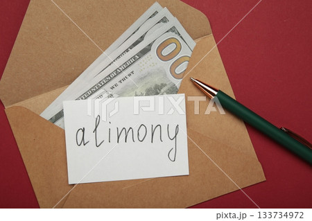 Envelope with word Alimony and money on red background. 133734972