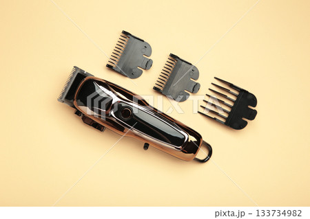 Hair clipper on beige background. Modern hair clipper. Hair clipper on beige background. Modern hair clipper. 133734982