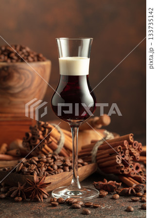 Coffee liquor with cream on a brown background. Coffee liquor with cream on a brown background. 133735142
