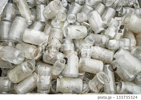 Photo of dirty, used glass jars and bottles. Photo of dirty, used glass jars and bottles. 133735324