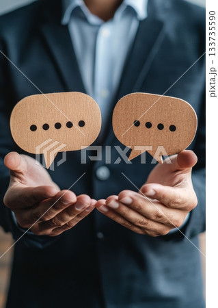 A Professional Businessman Dressed in a Suit Engaging with Various Conversation Bubbles Representing Ideas 133735590