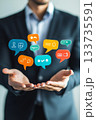 A Professional Businessman Dressed in a Suit Engaging with Various Conversation Bubbles Representing Ideas 133735591