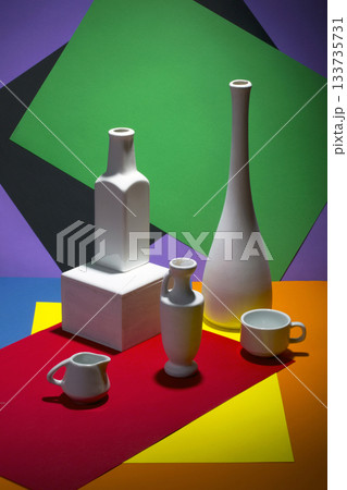 Still life with white vases on a color abstract background. 133735731