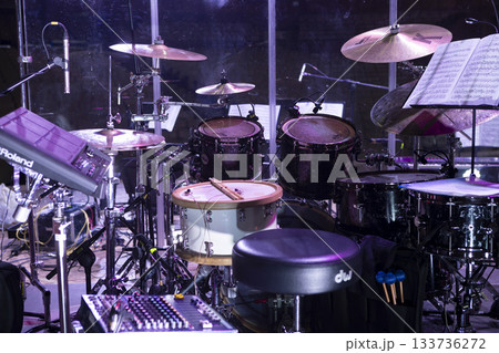 Drum kit on stage before a concert behind a screen 133736272