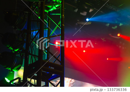 Dynamic concert lighting scene with a metal truss, multiple spotlights 133736336