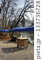 Calm Lakeside Park With Blue Umbrellas and Wooden Tables at Christmas Market in Bad Aibling 133736728