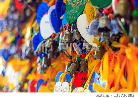 Brightly colored wooden heart-shaped signs with wishes and bells at Nanshan Park, Hainan, China. 133736892