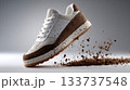 Dirty White Sneaker Kicking Up Soil Particles in Motion 133737548