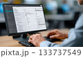 Businessman Typing on Office Computer with Management Software on Screen 133737549