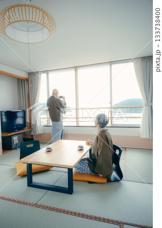 スマホで景色を撮る高齢夫婦の旅館シーン 133738400