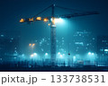 Tower crane illuminated at night over a foggy construction site with city lights 133738531